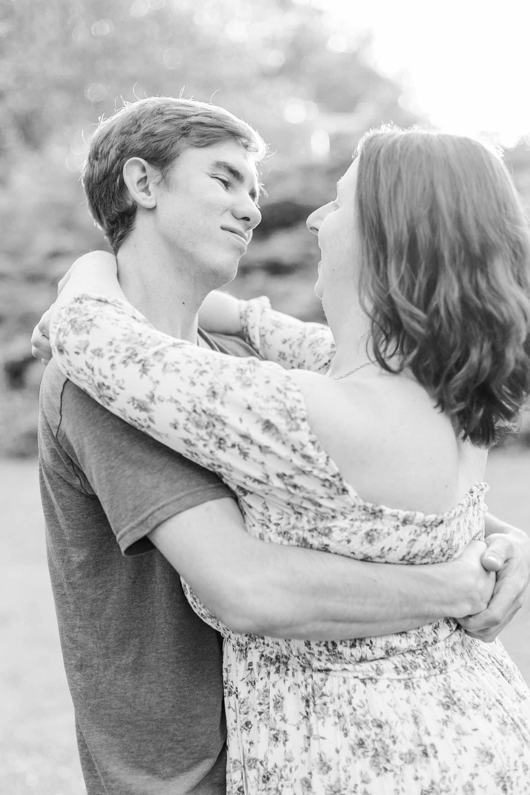 Couple stares lovingly at each other with arms wrapped around each other at Wadsworth Fall Engagement Session
