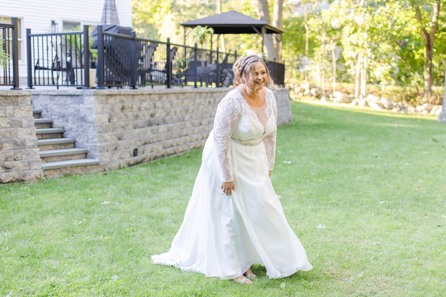 Bride smiles as she walks across the lawn for first look at Great Neck Country Club Wedding