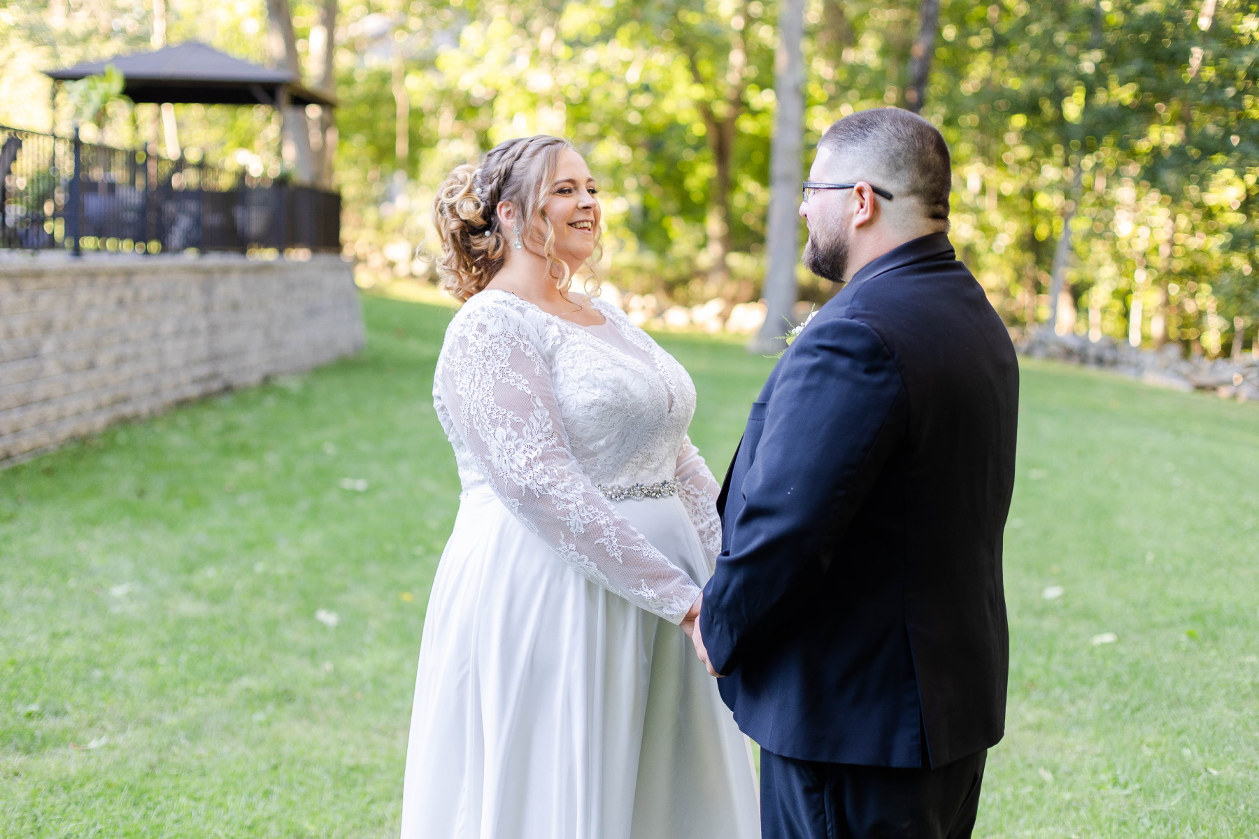 Bride and groom smile at each other during first look at Great Neck Country Club Wedding