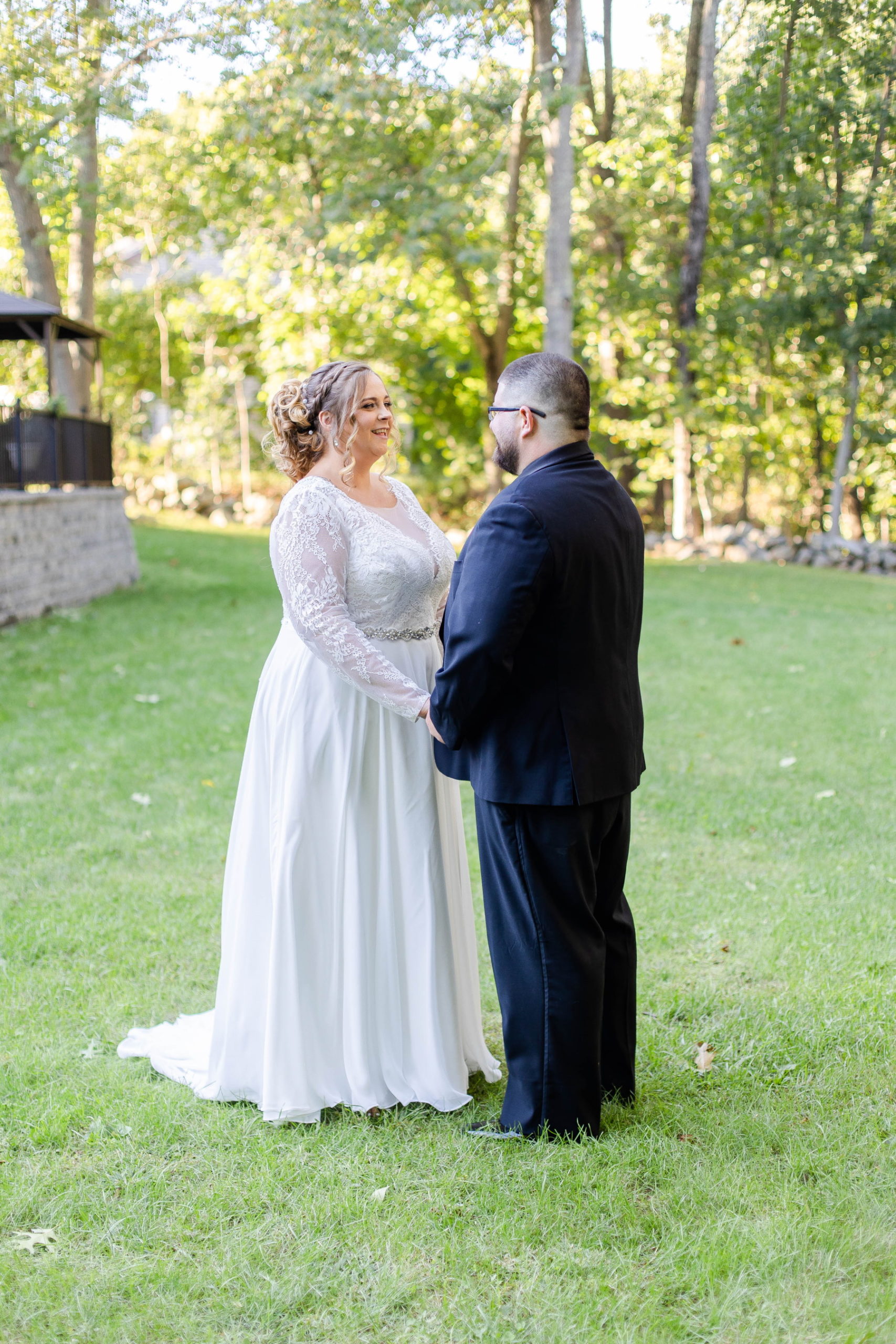 Bride smiles at groom during first look at Great Neck Country Club Wedding