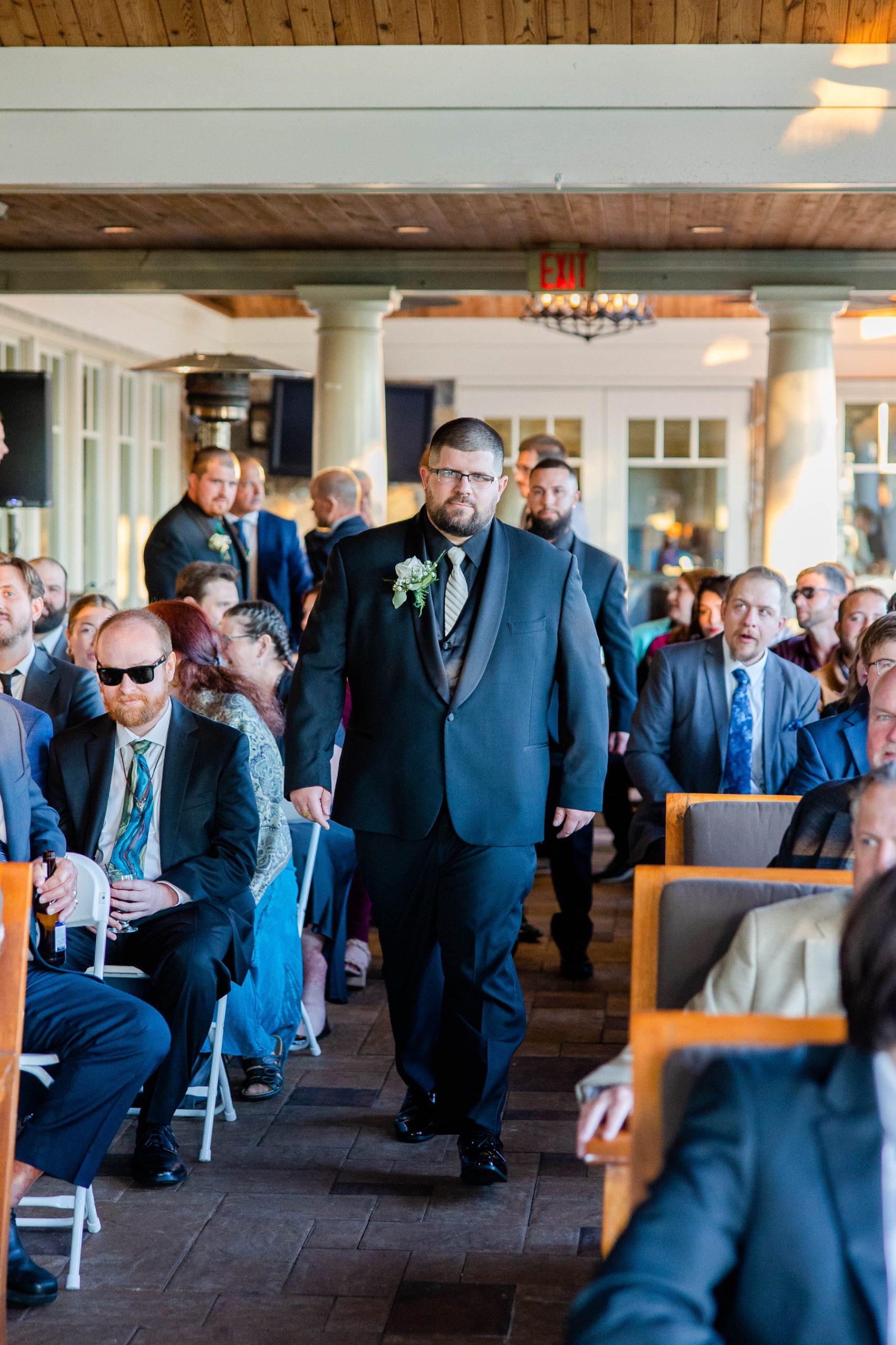 Groom walks down aisle during the ceremony at Great Neck Country Club Wedding
