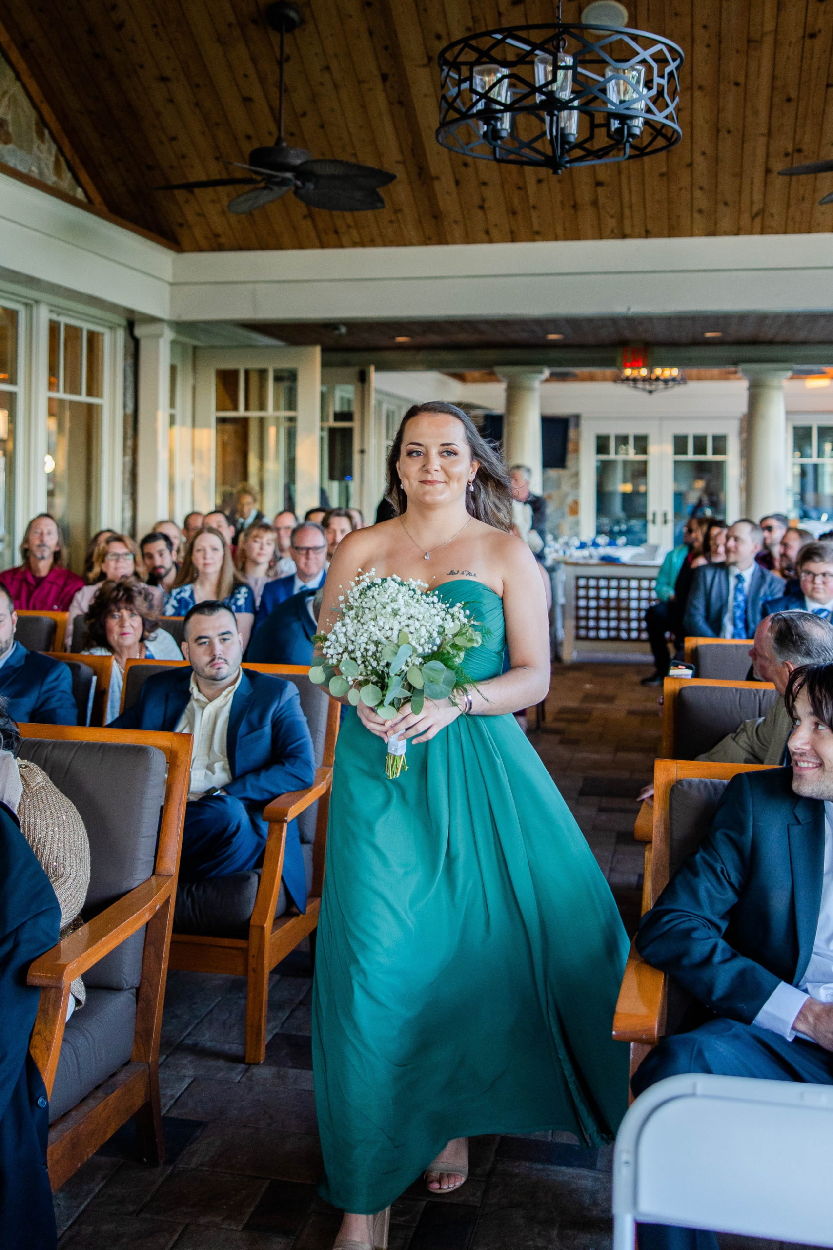 Maid of Honor walks down the aisle at the ceremony at Great Neck Country Club Wedding