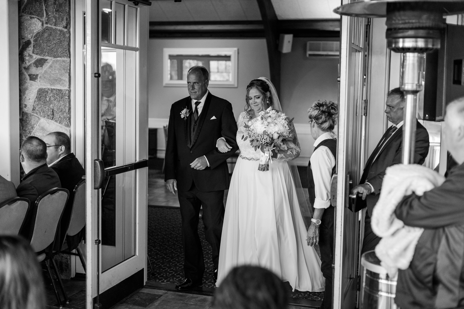 Bride and her father stand at the entrance before walking down the aisle during the ceremony at Great Neck Country Club Wedding