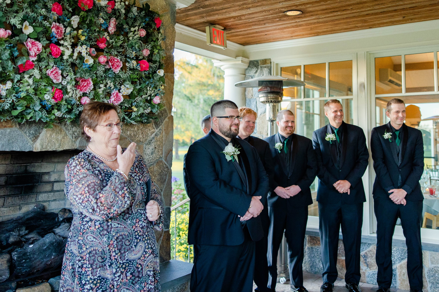 Groom and groomsmen smile as they see the bride walk down the aisle at Great Neck Country Club Wedding