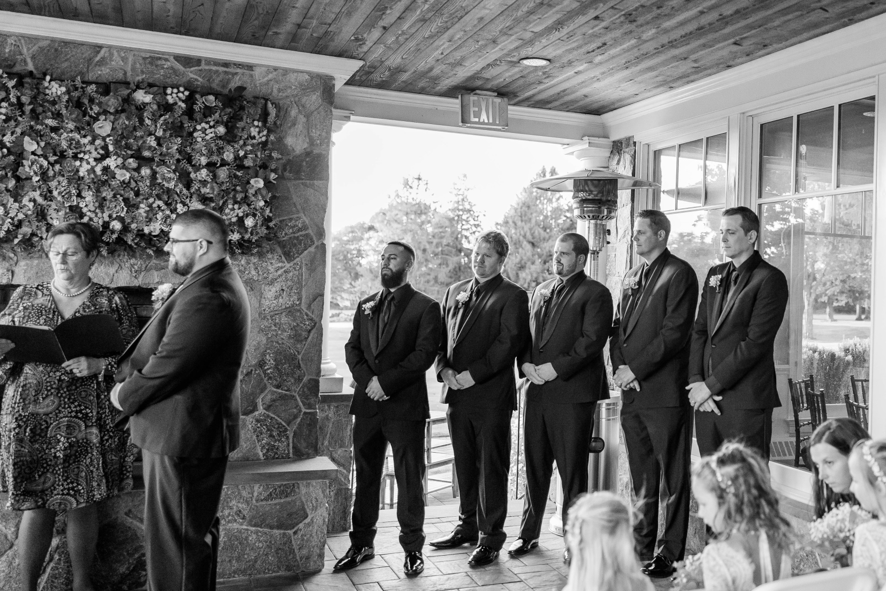 Groom and groomsmen stand during the ceremony at Great Neck Country Club Wedding