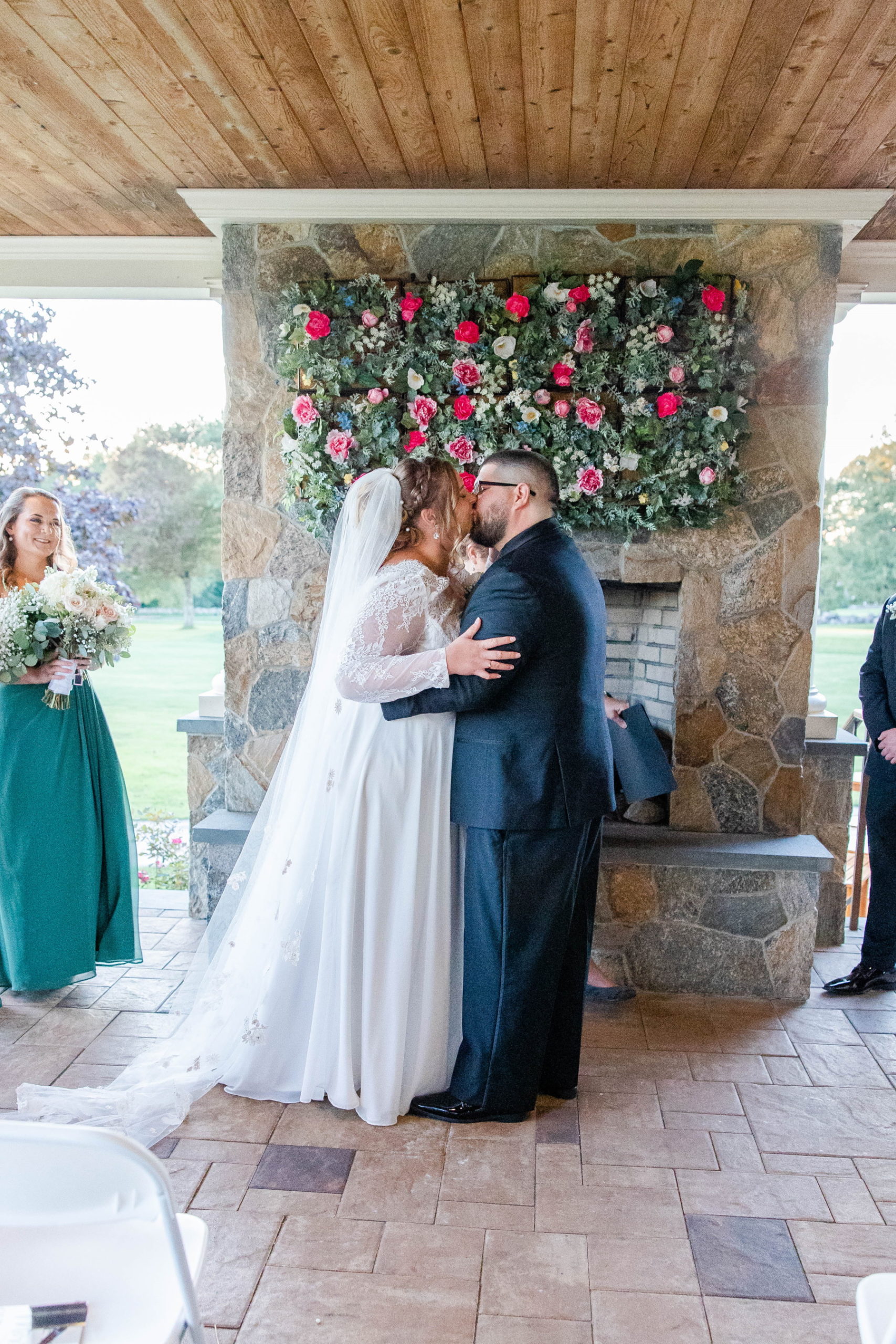 Bride and groom share first married kiss during ceremony at Great Neck Country Club Wedding