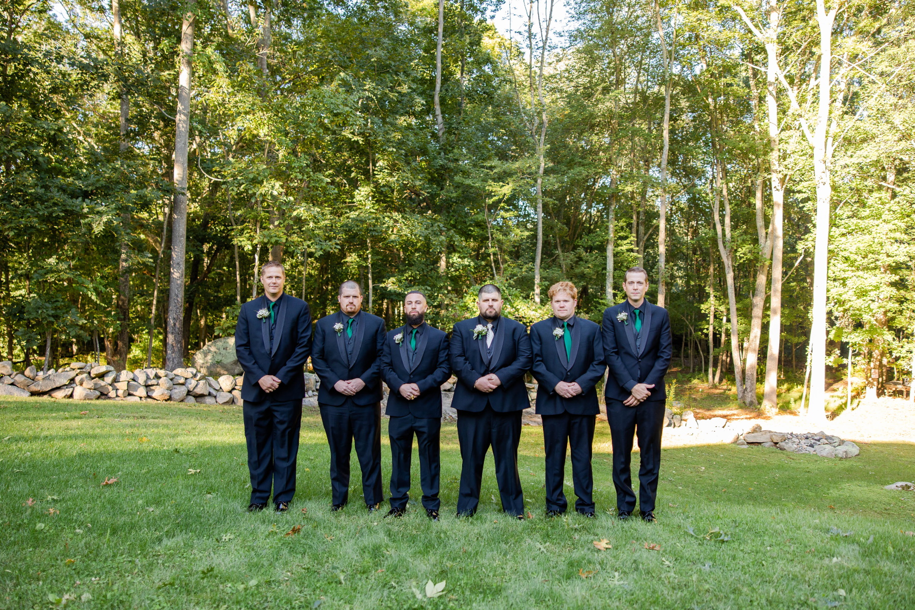 Groom and groomsmen stand serious looking at camera at Great Neck Country Club Wedding