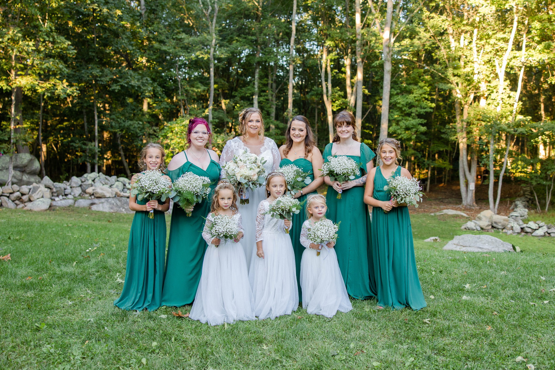 Bride stands smiling with bridesmaids and flower girls at Great Neck Country Club Wedding
