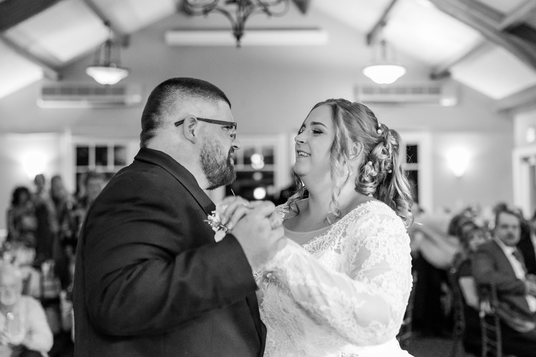 Bride and groom smile during their first dance at Great Neck Country Club Wedding