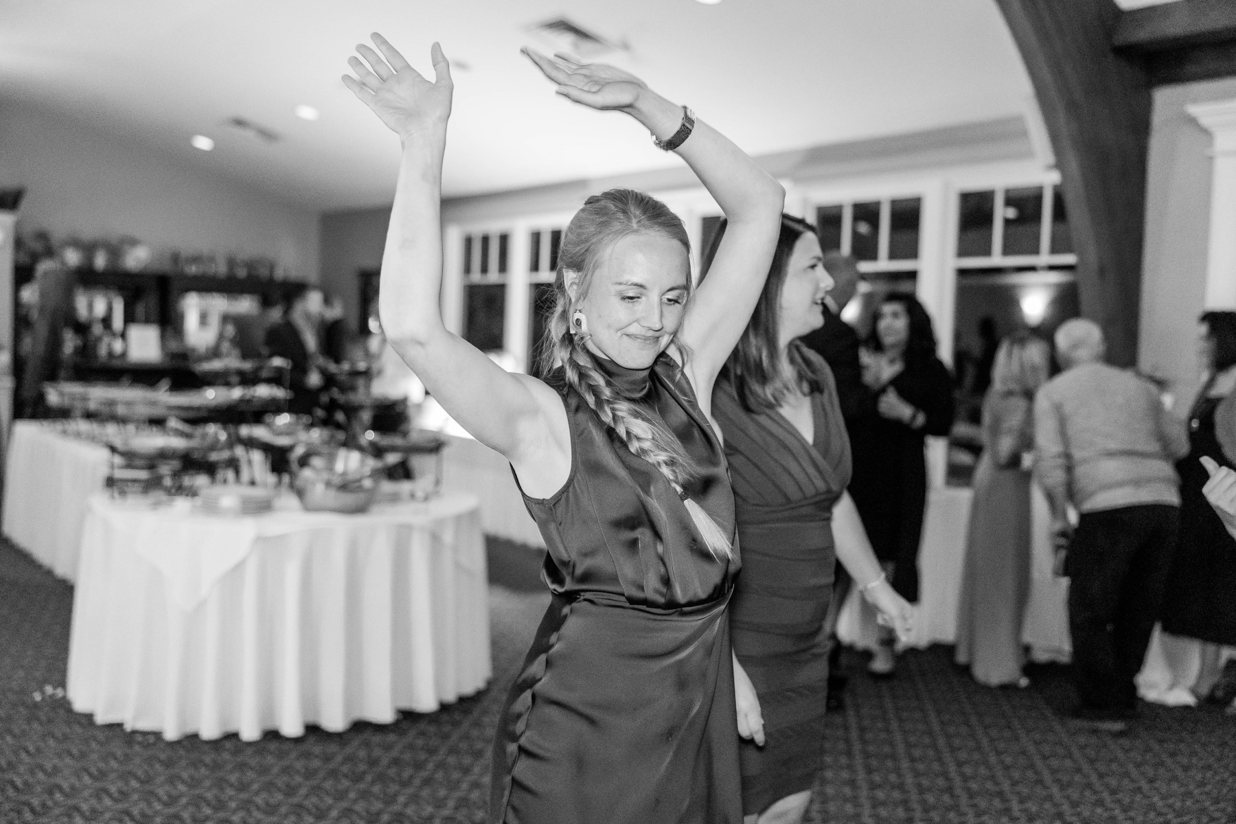 Wedding guest dances with her hands up at Great Neck Country Club Wedding