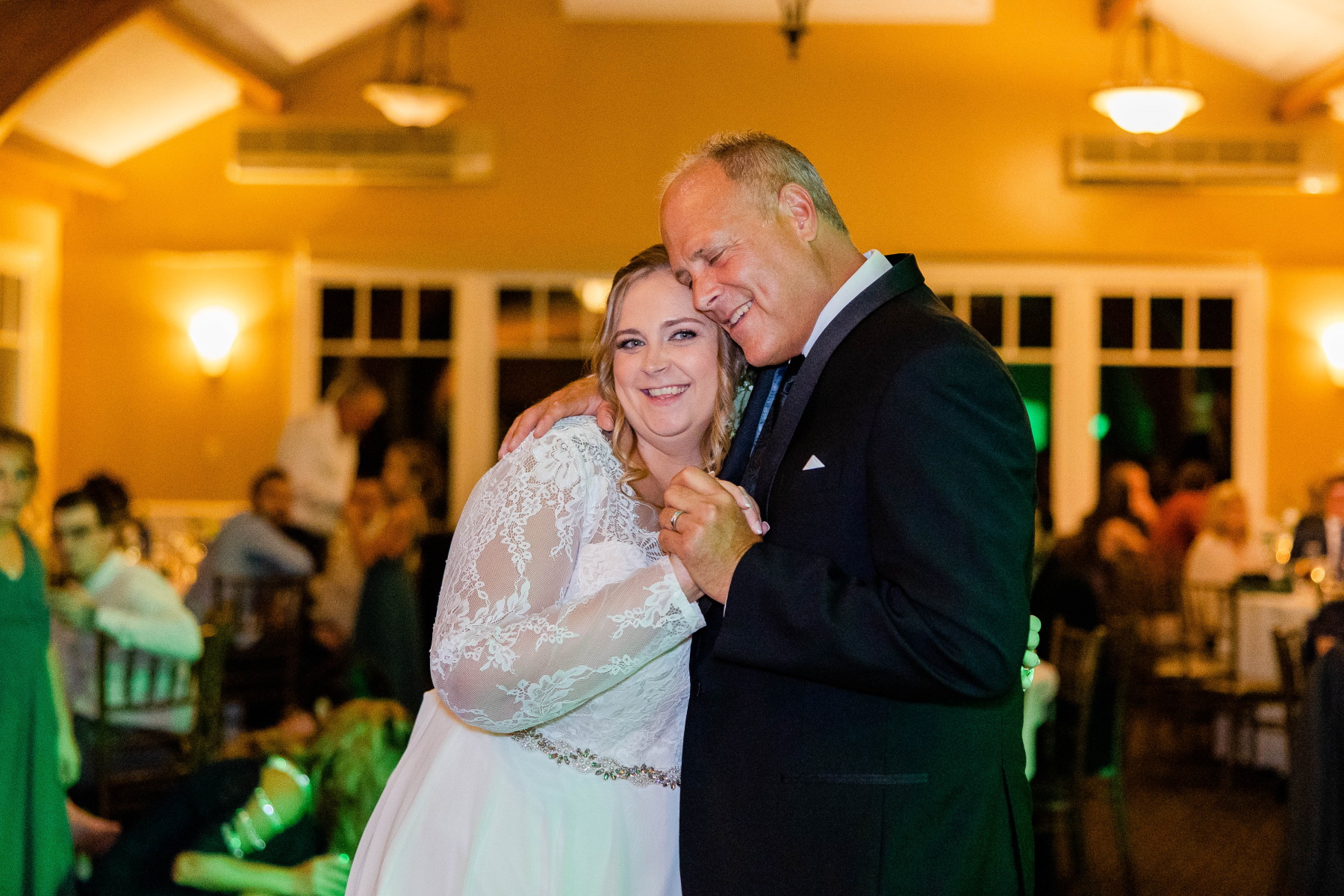 Bride smiles while dancing with her father at Great Neck Country Club Wedding