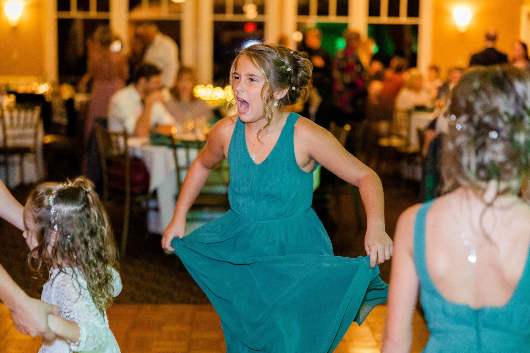 Junior bridesmaid excitedly sings while dancing at Great Neck Country Club Wedding