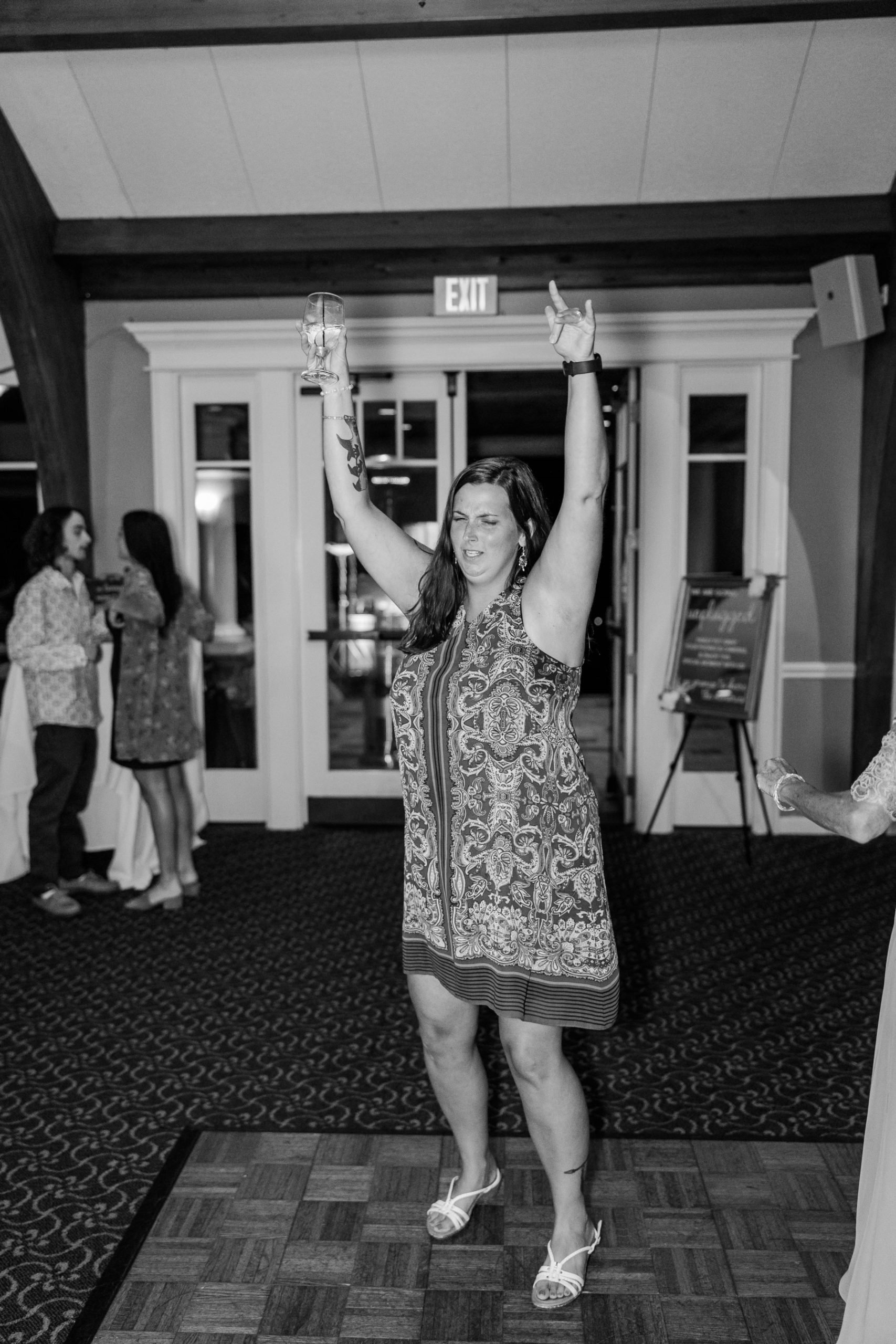 Wedding guest dances with hands up at Great Neck Country Club Wedding