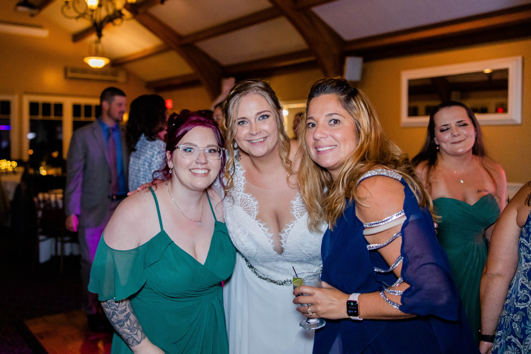 Bride smiles at camera with wedding guests at Great Neck Country Club Wedding