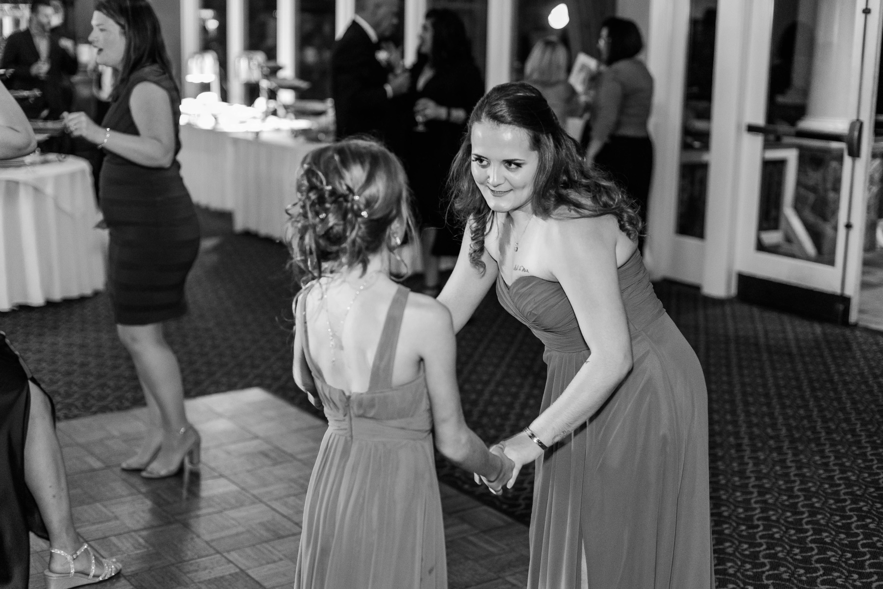 Maid of honor dances with a junior bridesmaid at Great Neck Country Club Wedding